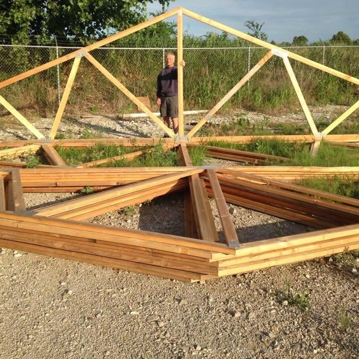 Green Country owner standing with wood roof trusses in the yard